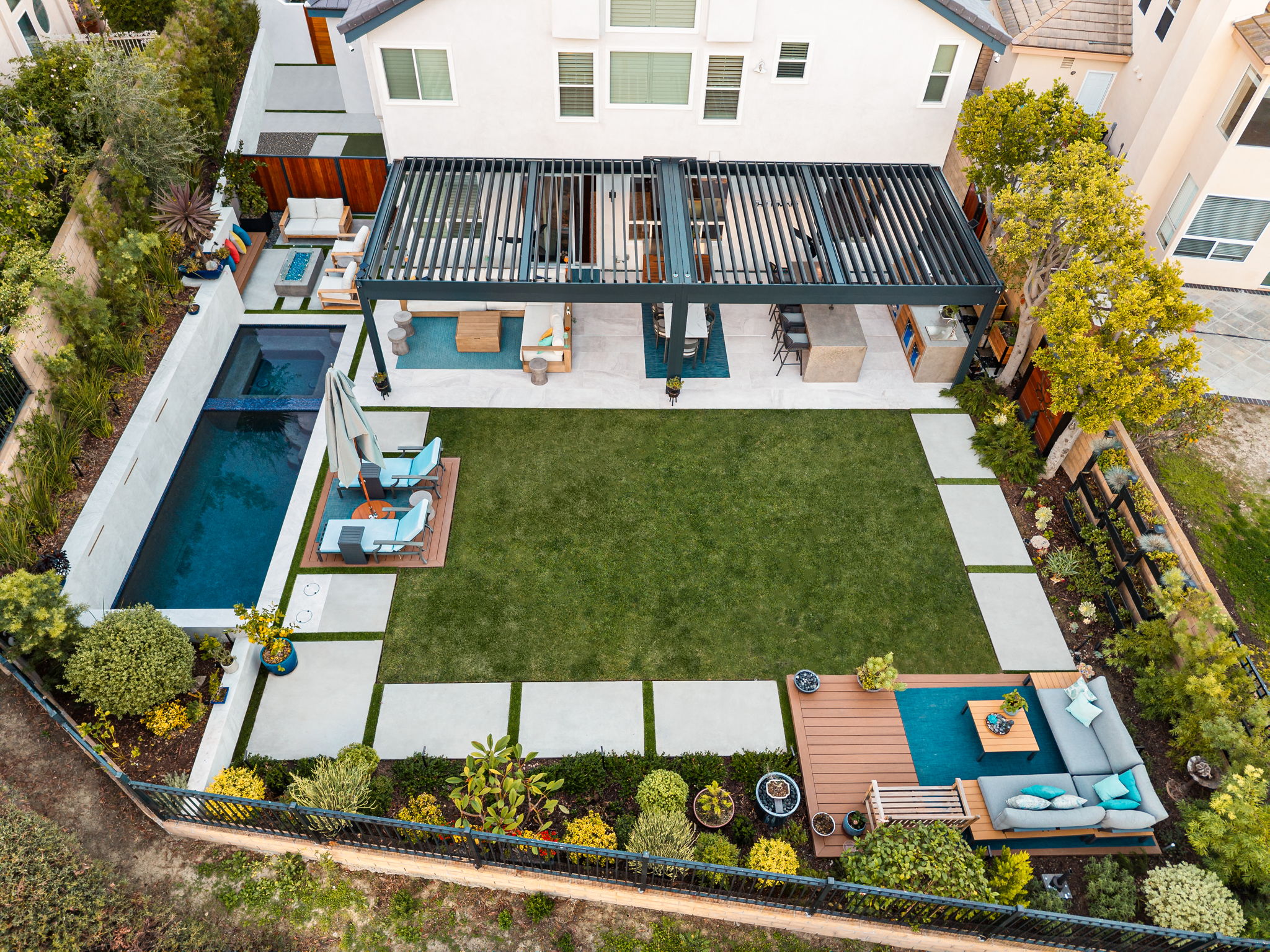 Aerial view of the finished Mission Viejo backyard showing the full layout of pergola, pool, and lawn